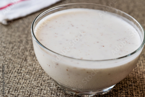 Organic probiotic milk kefir with flax seed in glass bowl.
