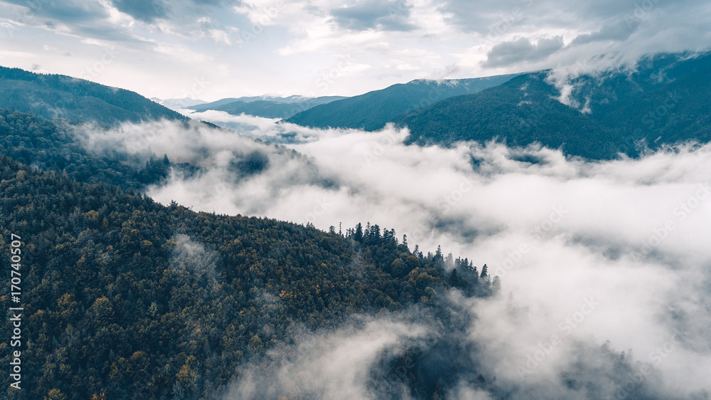 flying above the clouds in the mountains