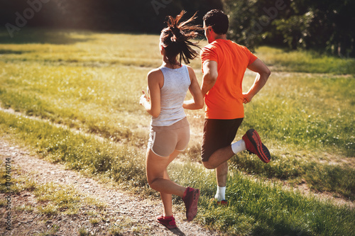 Fototapeta Naklejka Na Ścianę i Meble -  Happy couple running and jogging together