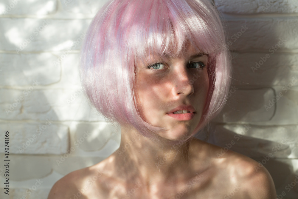 Woman posing in pink wig
