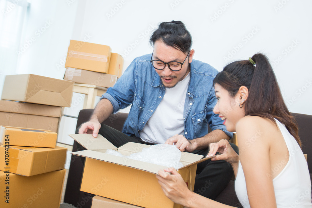 Couple Asian People Open the Box with Happy Emotion, People Feeling Surpise Togrther, People Moving Concept Couple Asian People Open the Box with Happy Emotion, People Feeling Surpise Togrther, People Moving Concept
