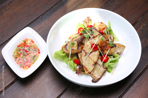 Grilled King Oyster Mushroom , Eryngii slices with sunflower sprout and green oak lettuce on white bowl