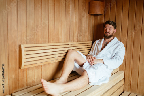 Handsome man relaxing in sauna