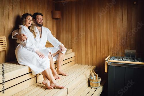 Beautiful couple relaxing in sauna