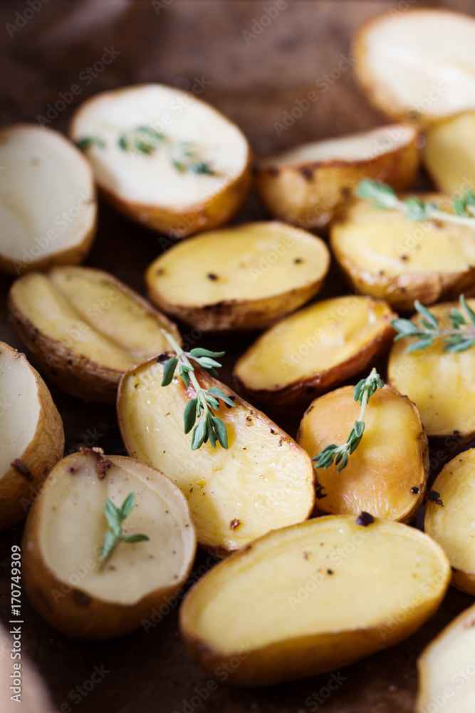 Baked spicy potatoes with thyme on parchment