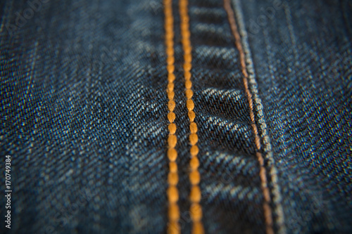 Jeans. Seam, yellow thread. Extremely close-ups.