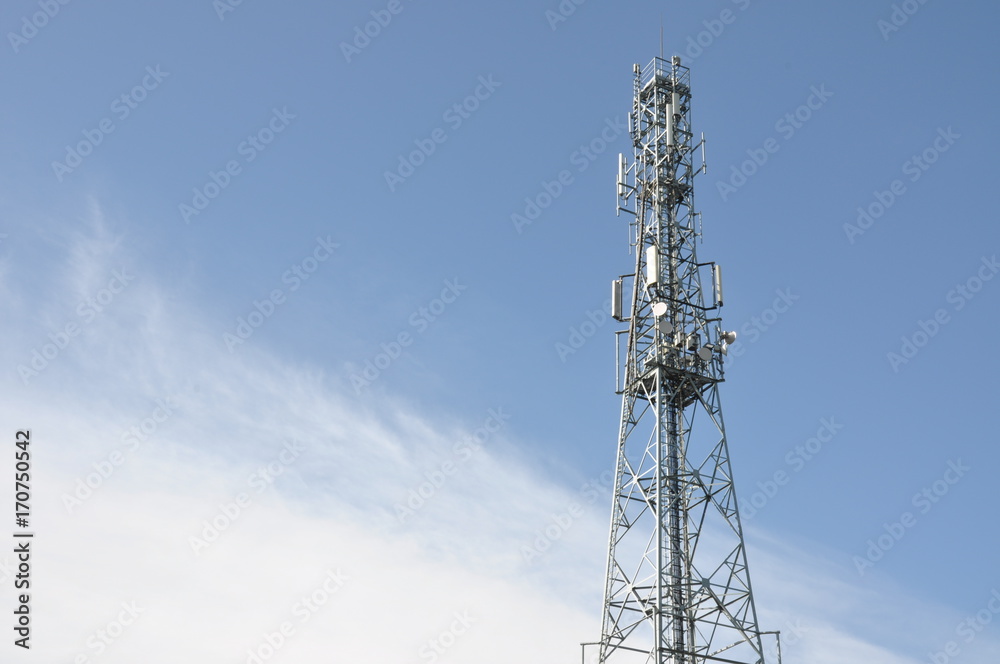 Telecommunication tower with blue and cloudy sky