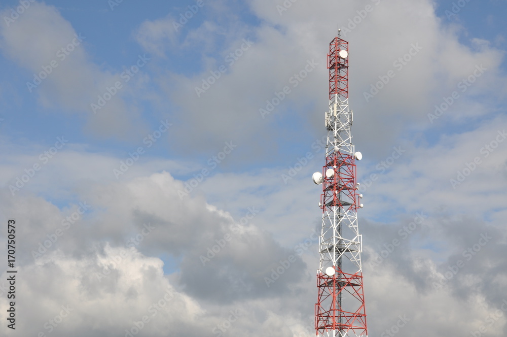 Telecommunication tower with blue and cloudy sky Telecommunication tower with blue and cloudy sky