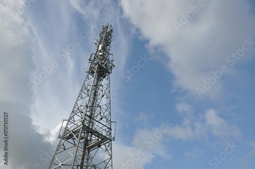 Telecommunication tower with blue and cloudy sky © salita2010