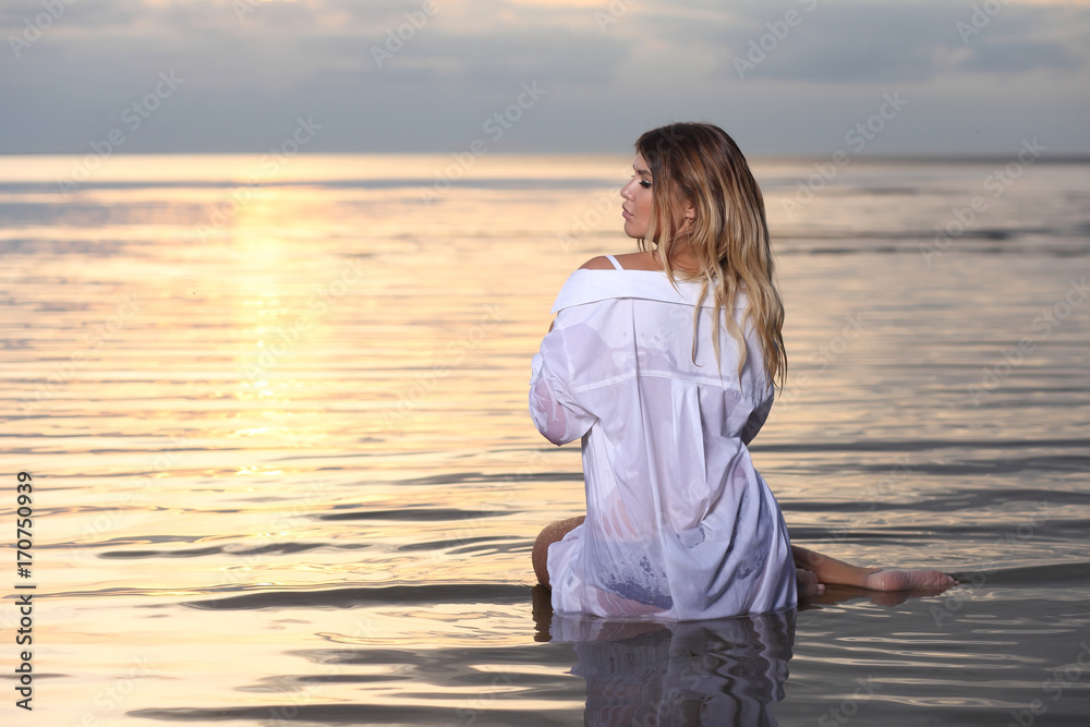 fashion photography with pretty woman in the water at sunset fashion photography with pretty woman in the water at sunset