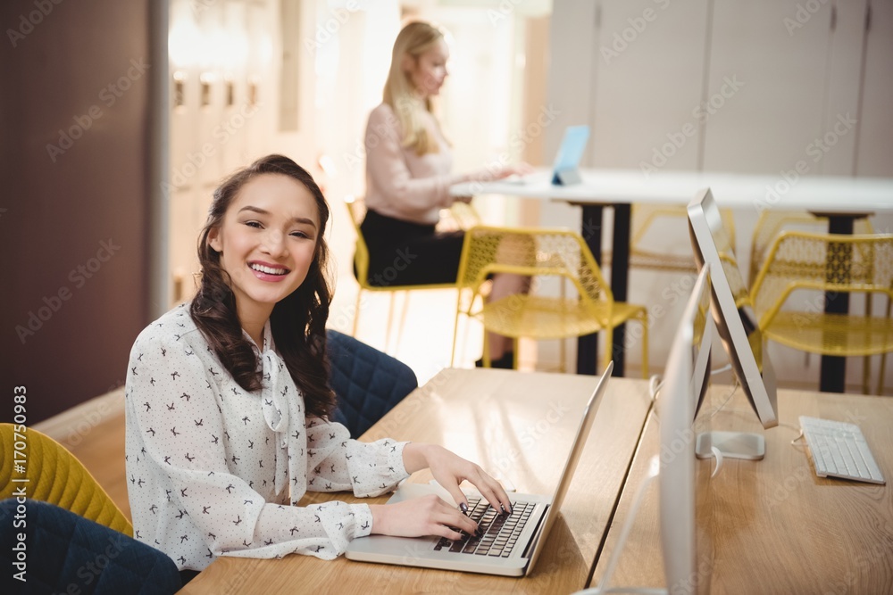 Portrait of female executive using laptop Portrait of female executive using laptop