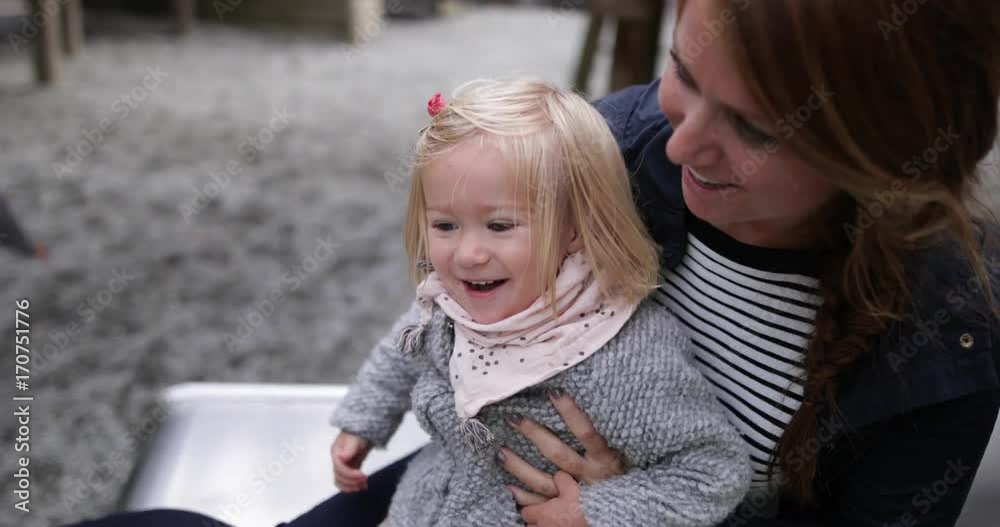 Mother and daughter in playground playing