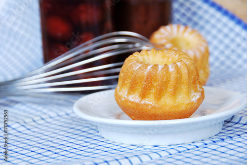 sweet muffins with icing sugar and a glass of milk