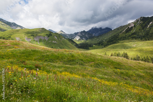 View of the Dolomites Alps with low clouds in the summer in northern Italy, Lombardy