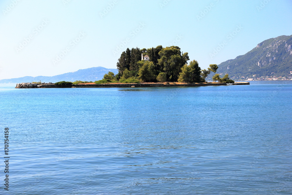 The islet of Pontikonisi - Mouse island on Corfu island, Greece. The islet of Pontikonisi - Mouse island on Corfu island, Greece.
