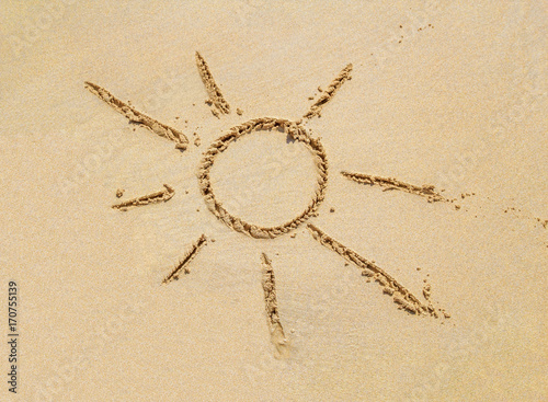 Beach sand surface with simple sun drawing