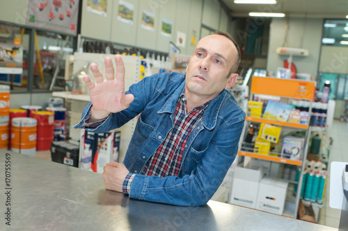 mature male customer seeking advise from seller at hardware store