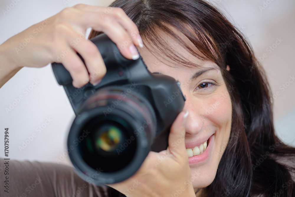 closeup image of pretty woman holding dslr camera closeup image of pretty woman holding dslr camera