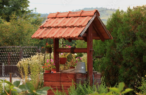 Wooden water well in the garden
