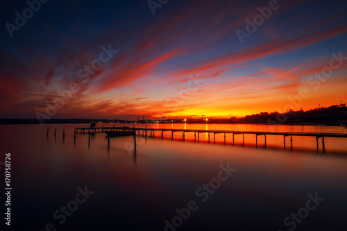 Wooden Dock and fishing boat at the lake, sunset shot