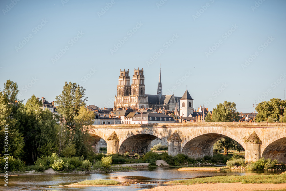 Landscape view on the river and old arch bridge in Orleans city during the sunset in France