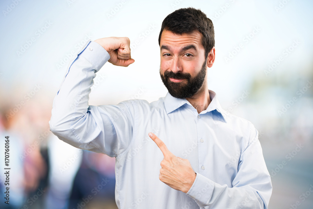 Handsome man with beard making strong gesture on unfocused background Handsome man with beard making strong gesture on unfocused background