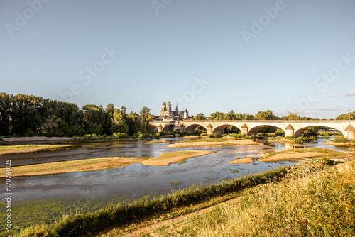 Landscape view on the river and old arch bridge in Orleans city during the sunset in France
