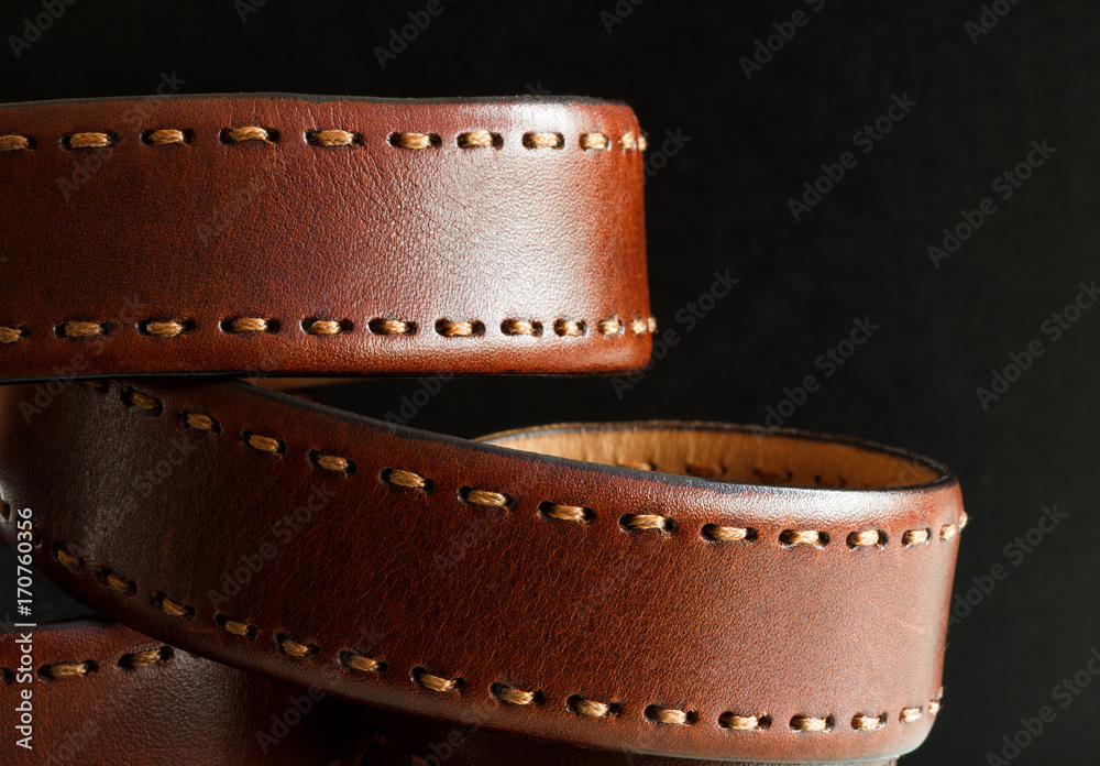 men's leather belt on a black background