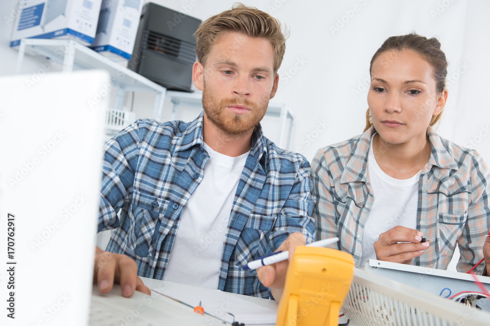co-workers using a calibrating device co-workers using a calibrating device