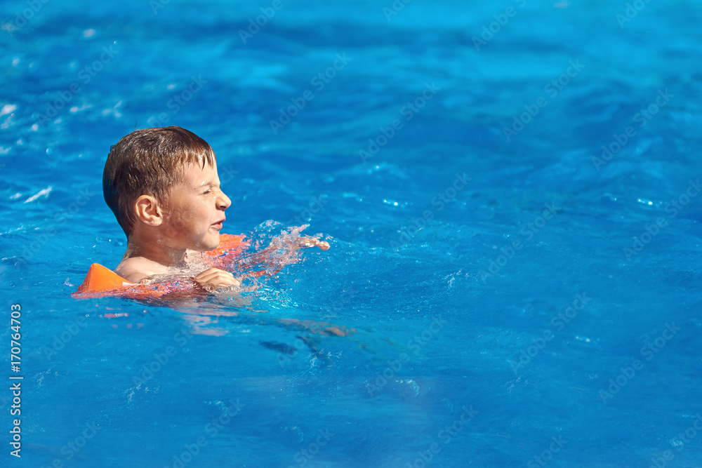 Caucasian boy swimming in the pool. Caucasian boy swimming in the pool.