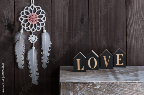 White dream catcher on brown background