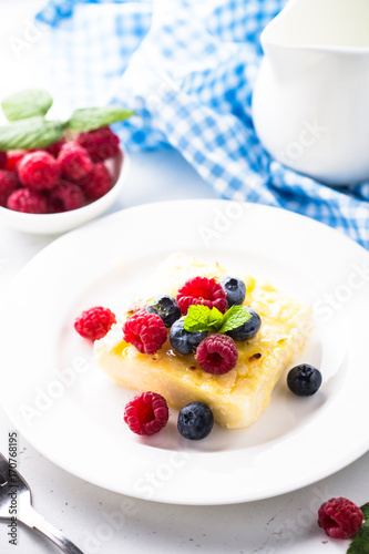 Cheesecake with fresh berries on white plate. Healthy breakfast.