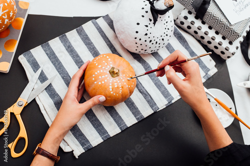 Woman Painting Halloween Pumkins photo