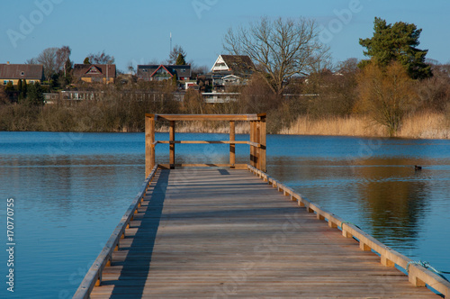 A wooden pier in town of Nyraad in Denmark photo