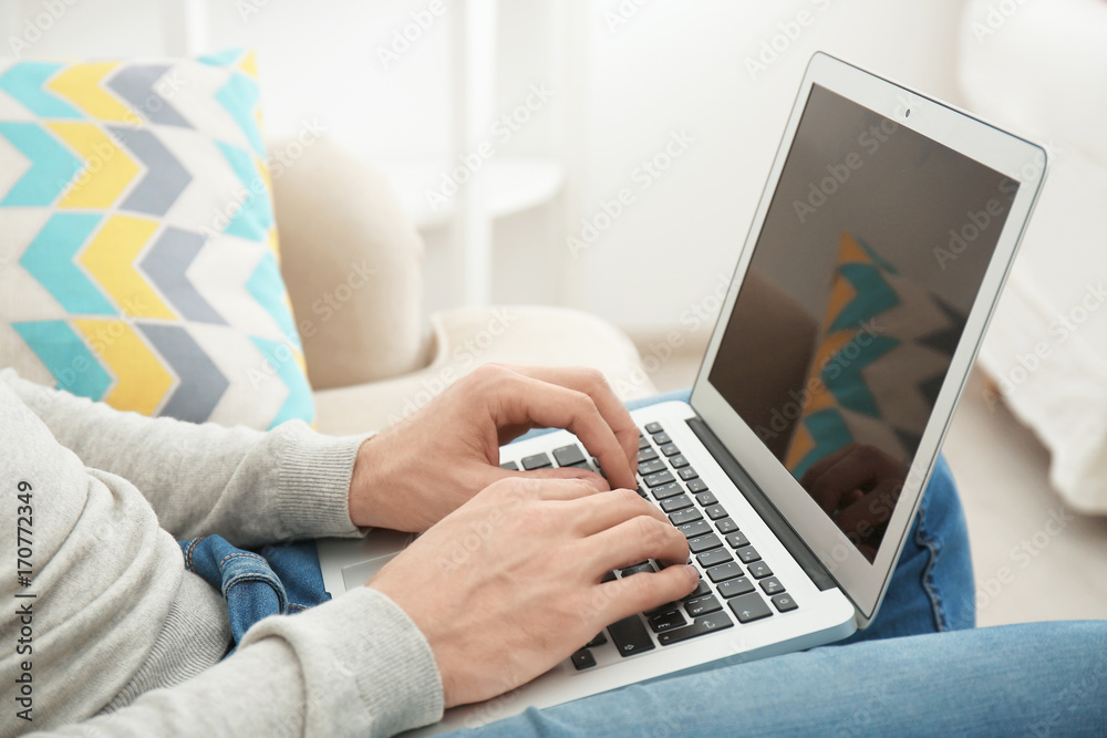 Young man working with laptop at home Young man working with laptop at home