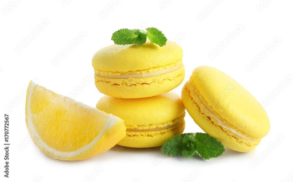 Lemon macarons with sliced fruit and mint leaves on white background Lemon macarons with sliced fruit and mint leaves on white background