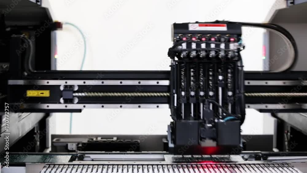 Automated Electronic circuit board production close up. Machine Produces Printed digital board, contract manufacturing. Manufacture of electronic chips. Robotic arm. Red light. Full HD. Contrast + Automated Electronic circuit board production close up. Machine Produces Printed digital board, contract manufacturing. Manufacture of electronic chips. Robotic arm. Red light. Full HD. Contrast +