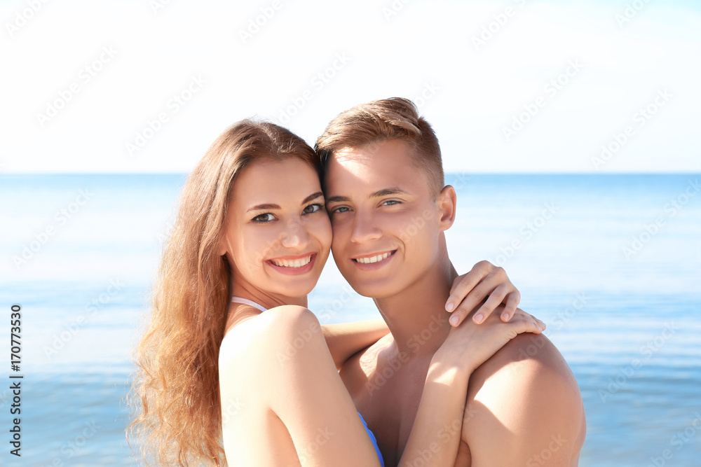 Happy young couple on sea beach at resort Happy young couple on sea beach at resort