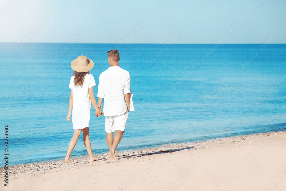 Happy young couple on sea beach at resort Happy young couple on sea beach at resort