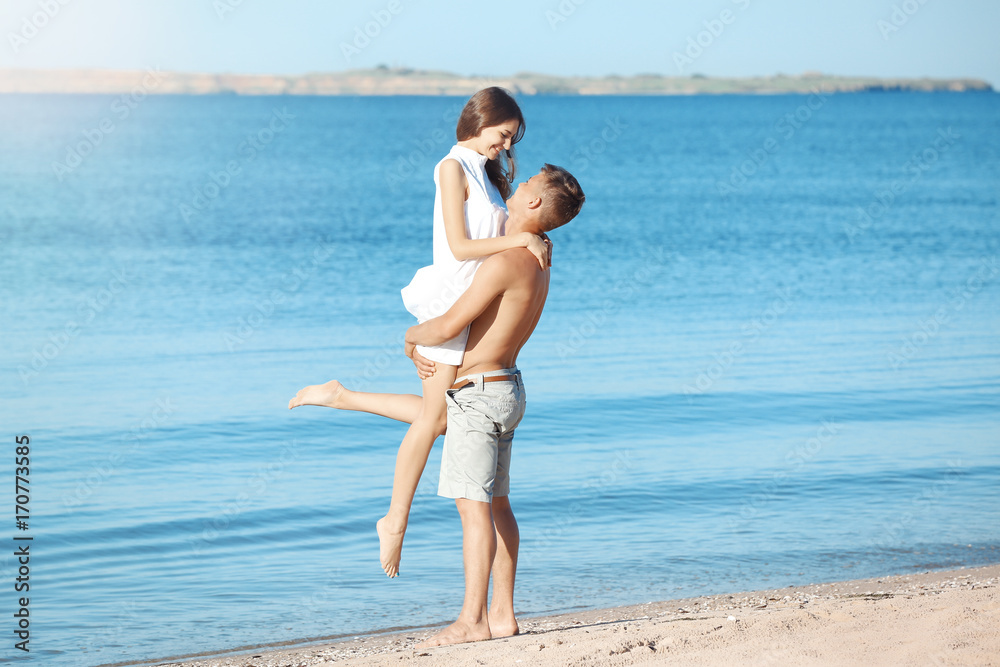 Happy young couple on sea beach at resort Happy young couple on sea beach at resort