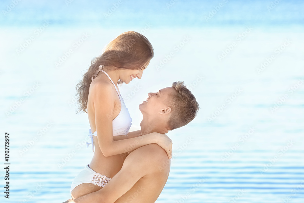 Happy young couple on sea beach at resort Happy young couple on sea beach at resort