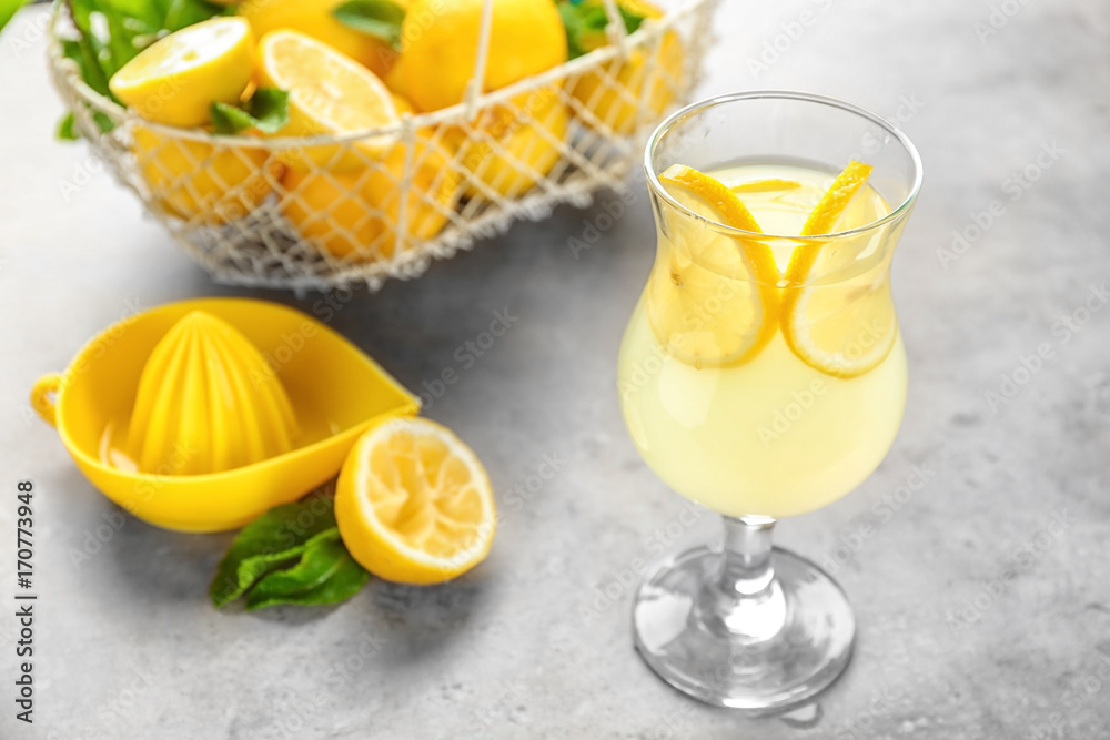 Composition with glass of lemon juice and fresh lemons on table Composition with glass of lemon juice and fresh lemons on table
