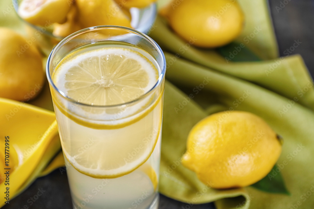 Composition with glass of lemon juice and fresh lemons on table, closeup Composition with glass of lemon juice and fresh lemons on table, closeup