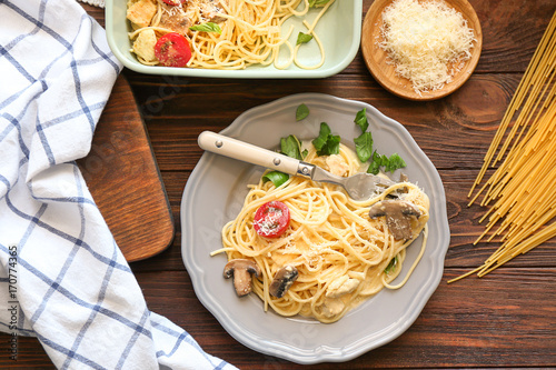 Plate with delicious roasted turkey tetrazzini on table photo