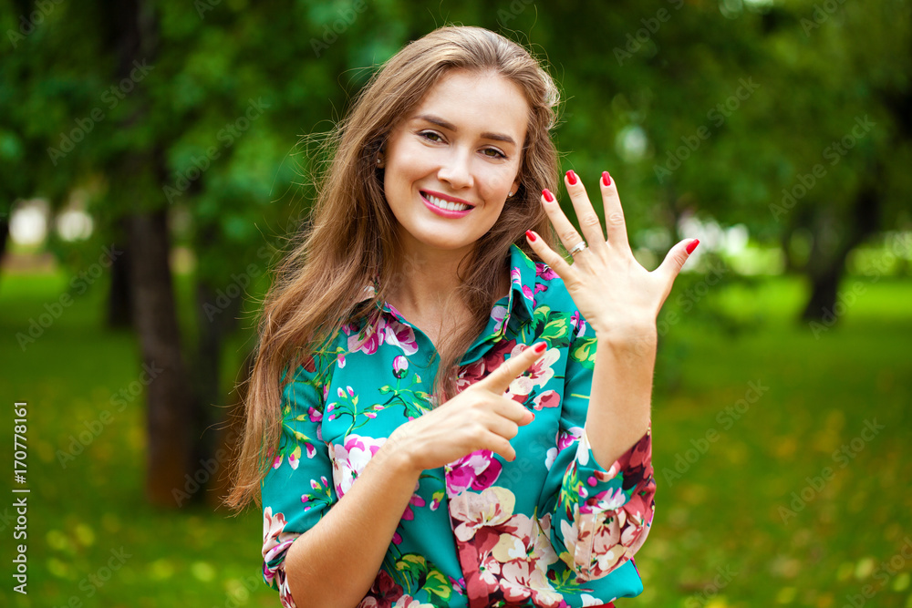 Happy beautiful woman showing her engagement ring Happy beautiful woman showing her engagement ring