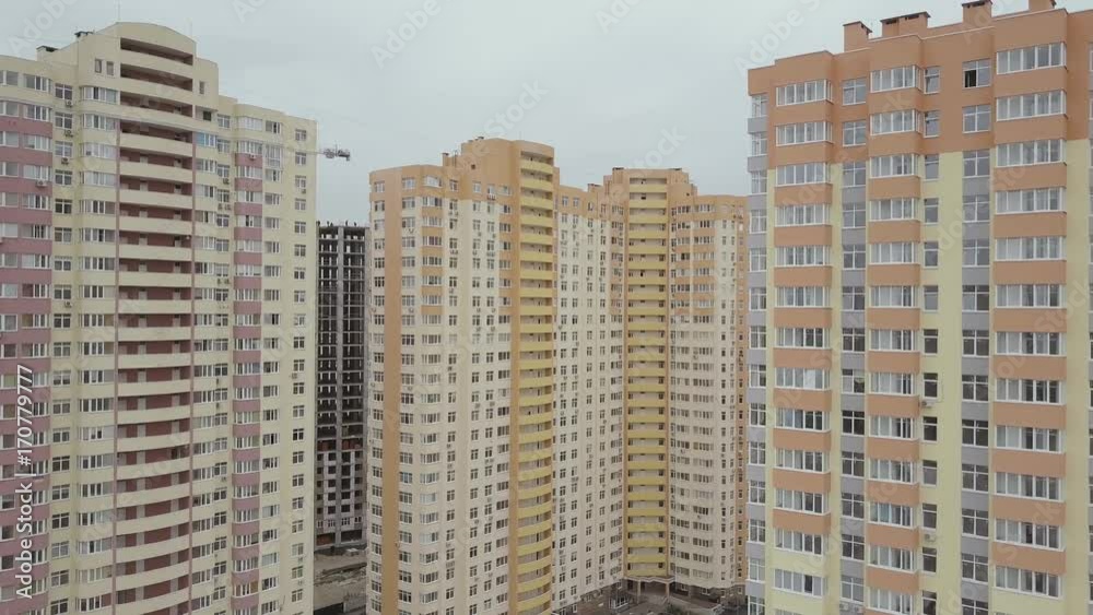 Aerial view. A complex of new high-rise apartment buildings in the city. Camera approaching buildings Aerial view. A complex of new high-rise apartment buildings in the city. Camera approaching buildings
