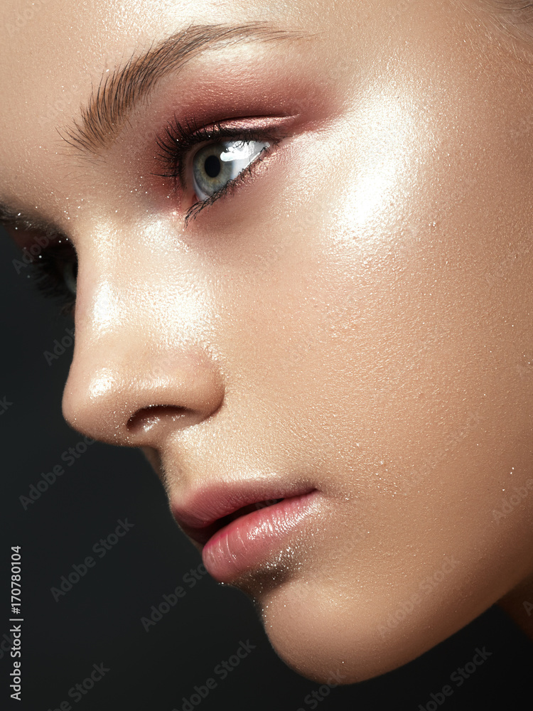 Beautiful young woman with perfect clean shiny skin, natural fashion  makeup. Close-up woman, fresh spa look. Smooth, shiny, well-groomed skin,  tan. Advertising. Stock Photo
