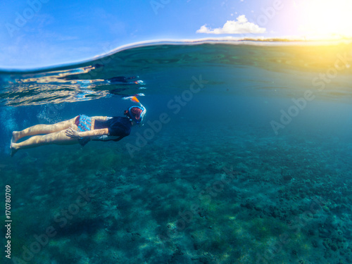 Woman swimming in blue sea. Snorkeling girl in full-face snorkeling mask.