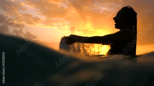 Sexy girl with wet hair and lips in the sunset in the water underwater  photo