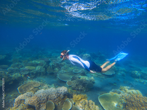 Male snorkel in tropical lagoon undersea photo. Snorkeling in coral reef. Summer holiday activity.